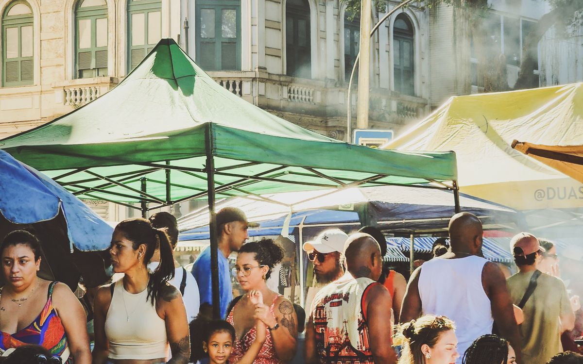 Visitors walking among outdoor food and market stalls
