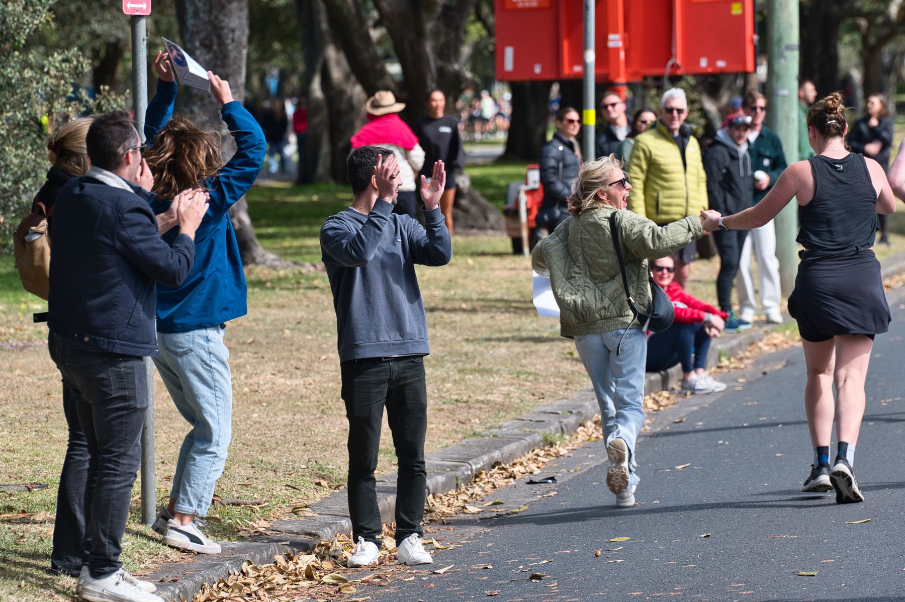 Spectators cheering runners during a community road race