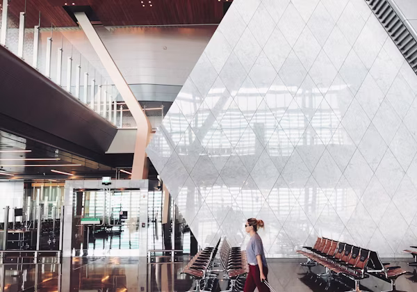 Traveller walking through a modern airport terminal