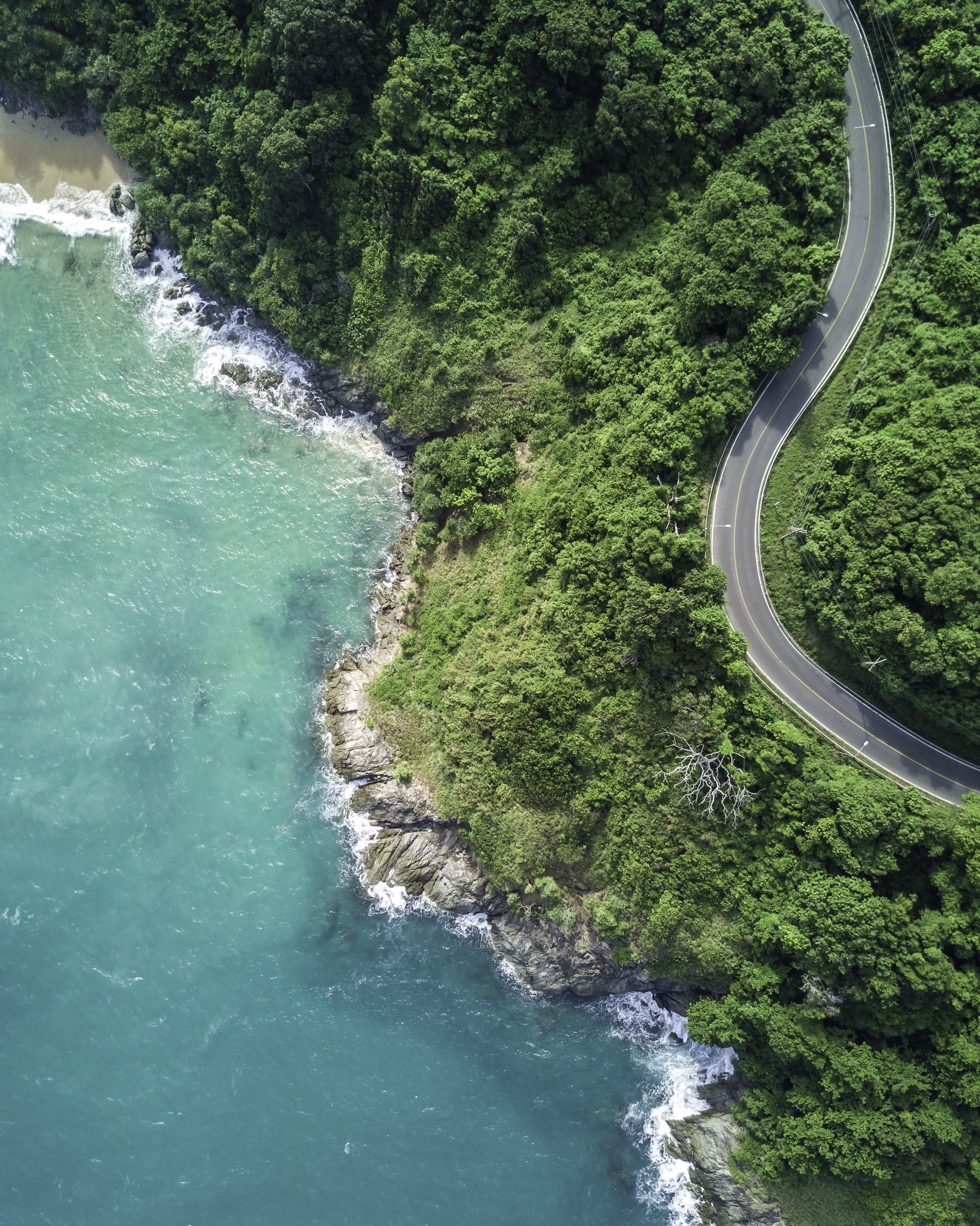 Aerial view of a coastal road and bridge in tropical Thailand
