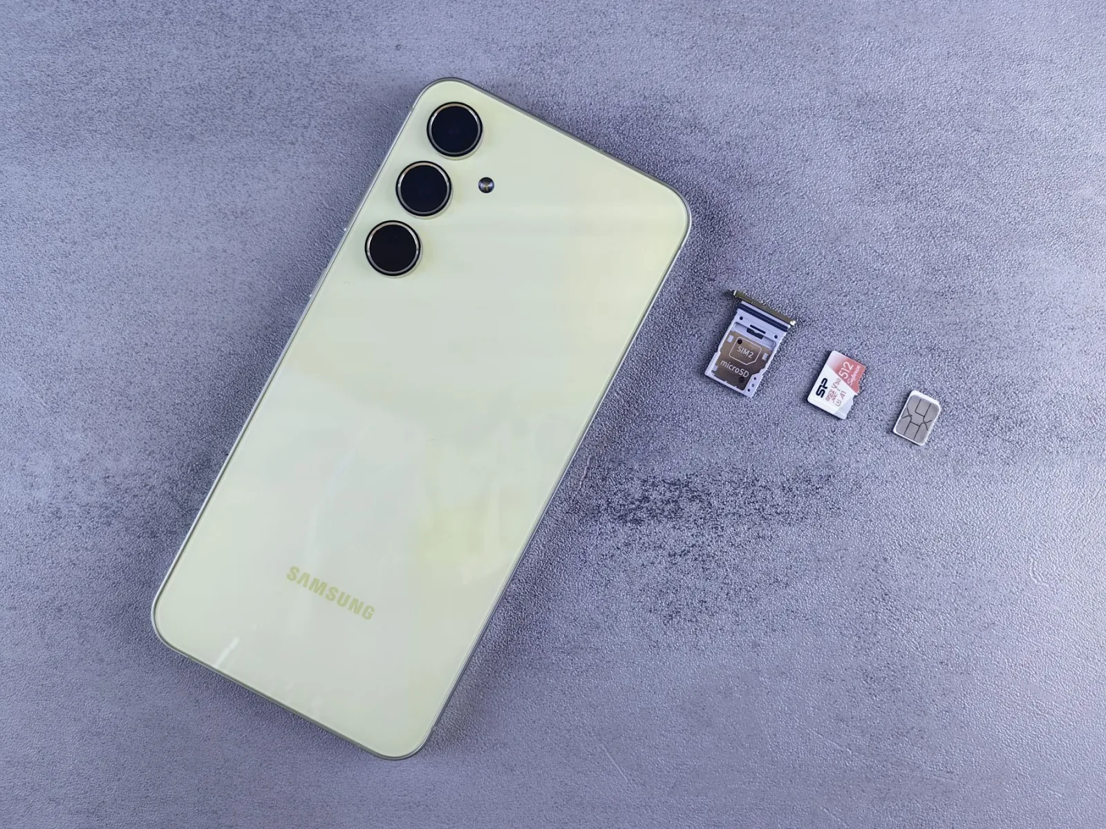 Smartphone, SIM card and memory card arranged on a neutral surface