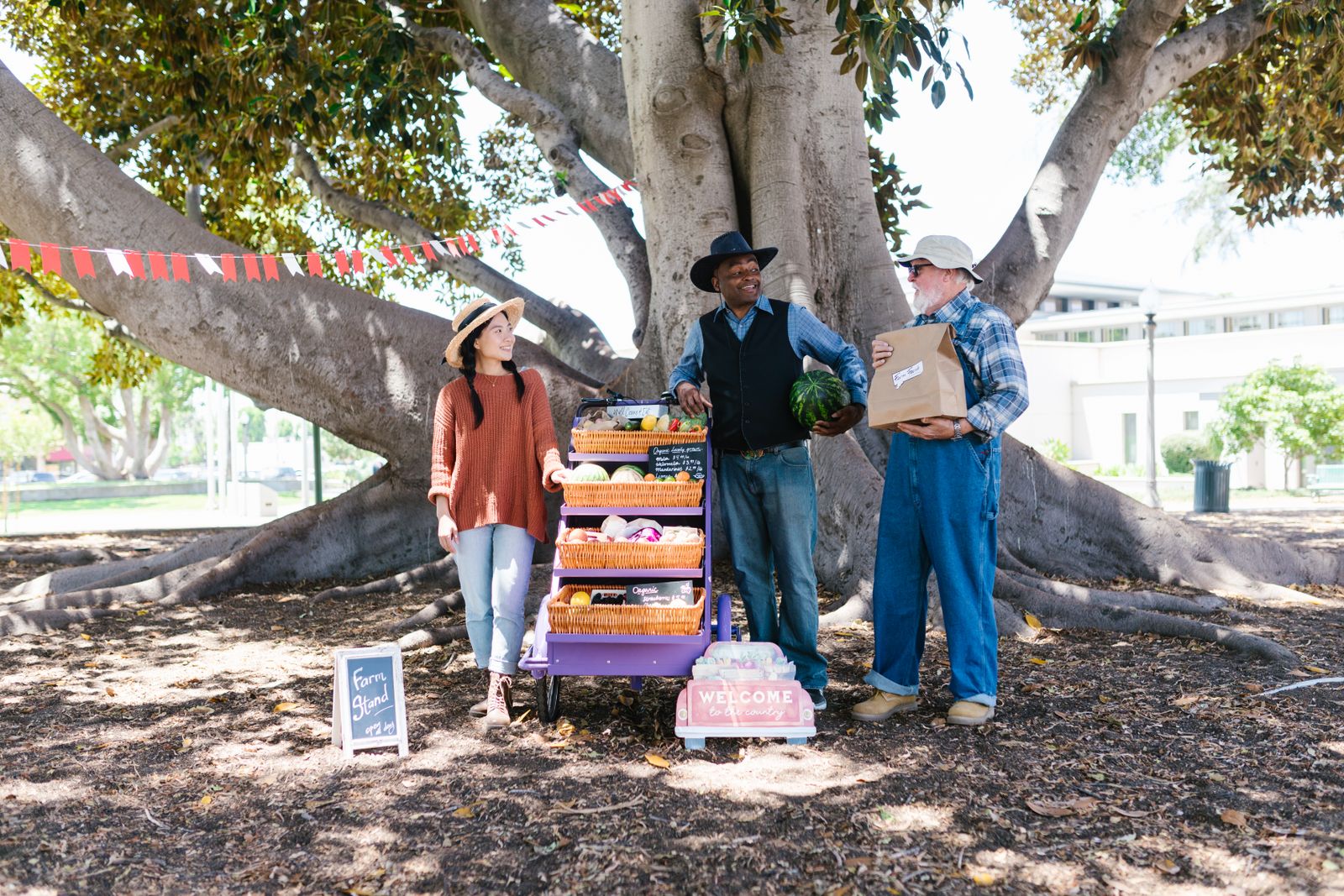 Growers presenting fresh produce at an outdoor farm market