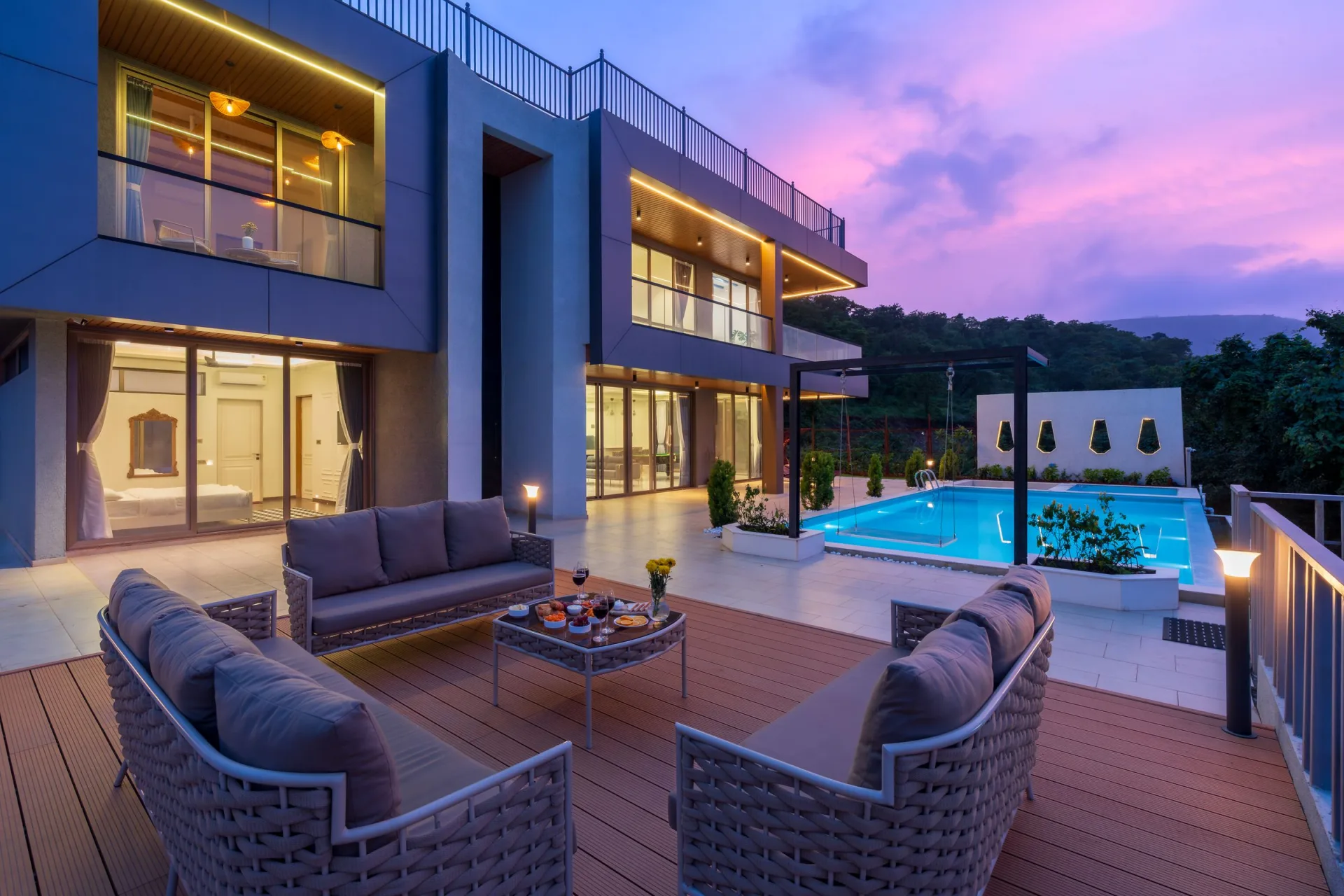 Modern villa and swimming pool at sunset